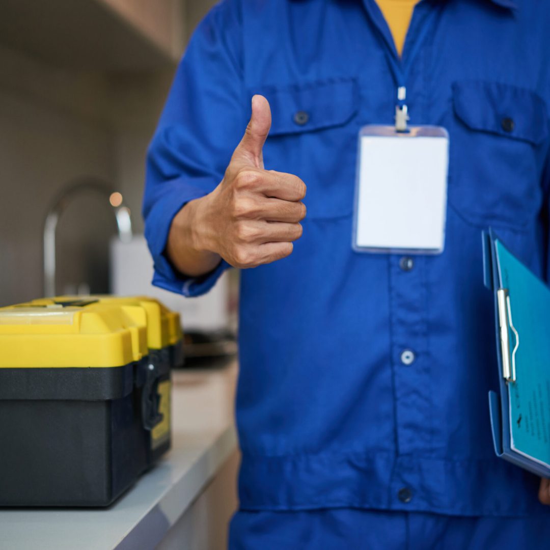 Good job Cropped image of repaiman with tool box showing thumbs-up